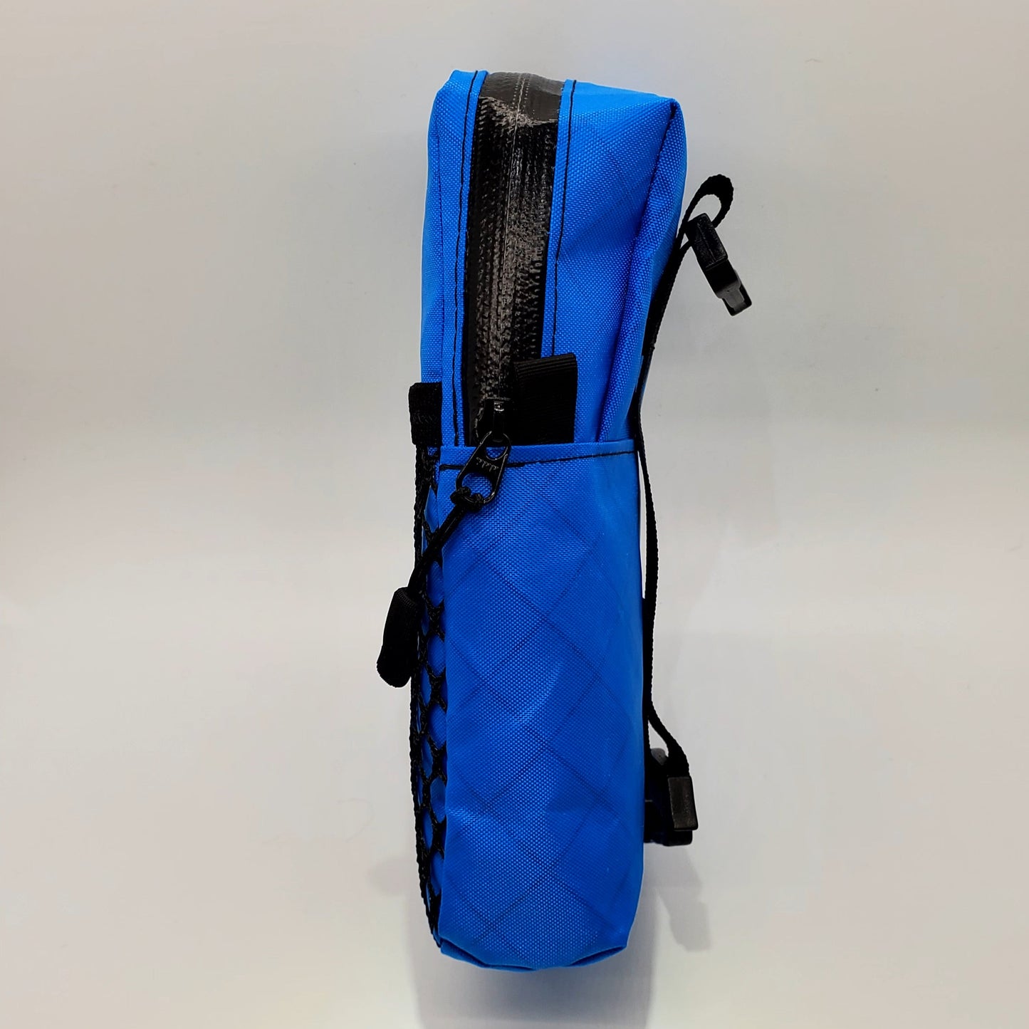 Bright blue hiking shoulder pouch side view